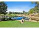 Tranquil community pond surrounded by lush landscaping and seating areas, ideal for relaxation at 175 Central Ave, Fayetteville, GA 30214