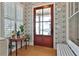 Charming foyer with wallpaper, hardwood floors, and a view of the glass front door at 175 Central Ave, Fayetteville, GA 30214