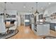 Eat-in kitchen with gray cabinets, stainless steel appliances, and a view of the dining area at 175 Central Ave, Fayetteville, GA 30214