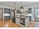 Beautiful kitchen with gray cabinetry, a center island, and modern appliances at 175 Central Ave, Fayetteville, GA 30214