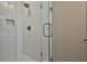 Modern glass shower with rainfall showerhead and beautiful white tile at 175 Central Ave, Fayetteville, GA 30214