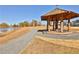 Picturesque view of a gazebo, lake and walking path on sunny day at 175 Central Ave, Fayetteville, GA 30214