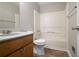 Bathroom featuring a vanity with storage, tile flooring, a toilet and shower-tub combination at 3694 Rolling Pl, Conley, GA 30288