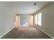 Bright bedroom featuring neutral carpet, gray walls and two windows at 3694 Rolling Pl, Conley, GA 30288