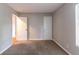 Neutral bedroom featuring tan carpet and two closets for ample storage at 3694 Rolling Pl, Conley, GA 30288
