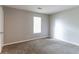 Neutral bedroom featuring carpet floors, light gray walls and trim, and one bright window at 3694 Rolling Pl, Conley, GA 30288