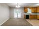 Cozy dining area with carpet flooring, french doors, neutral paint and access to a kitchen area at 3694 Rolling Pl, Conley, GA 30288
