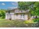 Rear exterior of home featuring a yard, siding and a set of double doors at 3694 Rolling Pl, Conley, GA 30288