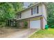 Two-story home featuring brick accents, siding, an attached garage, and a well-manicured lawn at 3694 Rolling Pl, Conley, GA 30288