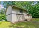 Exterior side view of home and yard with mature landscaping at 3694 Rolling Pl, Conley, GA 30288