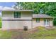 Side view of a two story home with siding and a yard surrounded by mature trees at 3694 Rolling Pl, Conley, GA 30288