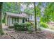 Inviting home exterior with a covered porch, complemented by lush landscaping and a driveway leading to a garage at 3694 Rolling Pl, Conley, GA 30288