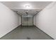Empty, one-car garage featuring a rolling door, concrete floor, and overhead light at 3694 Rolling Pl, Conley, GA 30288