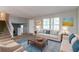 Comfortable living room with carpeted floor, neutral walls, and multiple windows for natural light at 3694 Rolling Pl, Conley, GA 30288
