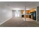 Spacious living room with carpet flooring, neutral paint, and an open layout leading to a kitchen area at 3694 Rolling Pl, Conley, GA 30288