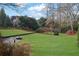 Well-maintained backyard features lush lawn and hardscape and mature landscaping for privacy at 4084 Peachtree Dunwoody Rd, Atlanta, GA 30342