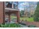 Expansive backyard with brick archways leading to a well-manicured lawn and garden at 4084 Peachtree Dunwoody Rd, Atlanta, GA 30342