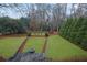 Picturesque backyard featuring manicured lawn with stone-lined planting beds and a fire pit at 4084 Peachtree Dunwoody Rd, Atlanta, GA 30342