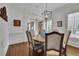 Dining room with a round table, hardwood floors, and white trim at 4084 Peachtree Dunwoody Rd, Atlanta, GA 30342