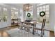 Bright dining room with large windows, decorative chandelier, and elegant hardwood floors at 4084 Peachtree Dunwoody Rd, Atlanta, GA 30342