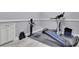 A home gym with a Total Gym machine, treadmill, weights, and plenty of storage at 4084 Peachtree Dunwoody Rd, Atlanta, GA 30342