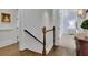 Upstairs hallway with hardwood floors and staircase with wooden banister at 4084 Peachtree Dunwoody Rd, Atlanta, GA 30342