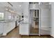 Gourmet kitchen featuring stainless steel refrigerator, wine storage, and ample cabinet space, and hardwood floors at 4084 Peachtree Dunwoody Rd, Atlanta, GA 30342