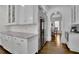 Kitchen with stainless steel refrigerator, white cabinets, and granite countertops at 4084 Peachtree Dunwoody Rd, Atlanta, GA 30342
