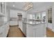 Well-appointed kitchen with granite countertops, stainless steel appliances, a center island, and french doors to patio at 4084 Peachtree Dunwoody Rd, Atlanta, GA 30342