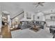 Open-concept living room with hardwood floors, stairs, archways, and abundant natural light at 4084 Peachtree Dunwoody Rd, Atlanta, GA 30342