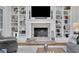 Living room features a fireplace and built-in bookshelves at 4084 Peachtree Dunwoody Rd, Atlanta, GA 30342