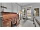 Spacious staged main bedroom with a beautiful rolltop desk, seating area, and ample natural light at 4084 Peachtree Dunwoody Rd, Atlanta, GA 30342