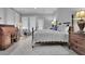 A staged main bedroom is spacious with beautiful floors and ample natural light at 4084 Peachtree Dunwoody Rd, Atlanta, GA 30342
