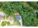 Aerial view showcases the home's placement amidst a dense forest, offering privacy at 4459 Grady Smith Rd, Loganville, GA 30052