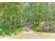 Picturesque backyard with a walking path winding through a serene wooded landscape at 4459 Grady Smith Rd, Loganville, GA 30052