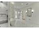 Modern bathroom featuring marble tile, a walk-in shower, and a freestanding tub at 4459 Grady Smith Rd, Loganville, GA 30052