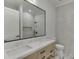 Modern bathroom featuring a double sink vanity, marble floors, and a glass-enclosed shower at 4459 Grady Smith Rd, Loganville, GA 30052