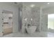 Elegant bathroom featuring a modern tub, walk-in shower, and access to a spacious closet at 4459 Grady Smith Rd, Loganville, GA 30052