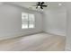 Sunlit bedroom boasts hardwood floors, ceiling fan, and a large window with a beautiful view at 4459 Grady Smith Rd, Loganville, GA 30052