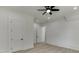 Bright bedroom features hardwood floors, a ceiling fan, and a door leading to another room at 4459 Grady Smith Rd, Loganville, GA 30052