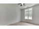 Bright bedroom features a window with a view of the lush outdoor surroundings and a ceiling fan at 4459 Grady Smith Rd, Loganville, GA 30052