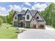 Beautiful exterior view of a modern two-story home with a large driveway and well-maintained garden at 4459 Grady Smith Rd, Loganville, GA 30052