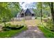 Stunning home exterior with manicured lawn, stonework, and a charming covered porch at 4459 Grady Smith Rd, Loganville, GA 30052