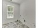 Bright laundry room with herringbone floors and a window offering natural light at 4459 Grady Smith Rd, Loganville, GA 30052