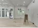 Living area featuring hardwood floors, large windows, custom millwork, and bright natural light at 4459 Grady Smith Rd, Loganville, GA 30052