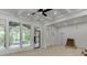 Light filled living room with large windows, coffered ceiling, and access to the outdoor balcony at 4459 Grady Smith Rd, Loganville, GA 30052