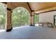 Spacious patio includes a brick fireplace, brick columns, wood ceiling, and an outdoor kitchen at 4459 Grady Smith Rd, Loganville, GA 30052