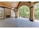 Expansive outdoor patio with a brick fireplace and a scenic view of the surrounding trees at 4459 Grady Smith Rd, Loganville, GA 30052