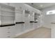 Custom walk-in closet with ample shelving, drawers, and hanging space provides plenty of storage solutions at 4459 Grady Smith Rd, Loganville, GA 30052