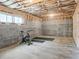 Unfinished basement featuring block walls, exposed wood beams, and potential for a workout area at 5728 Williams Rd, Norcross, GA 30093
